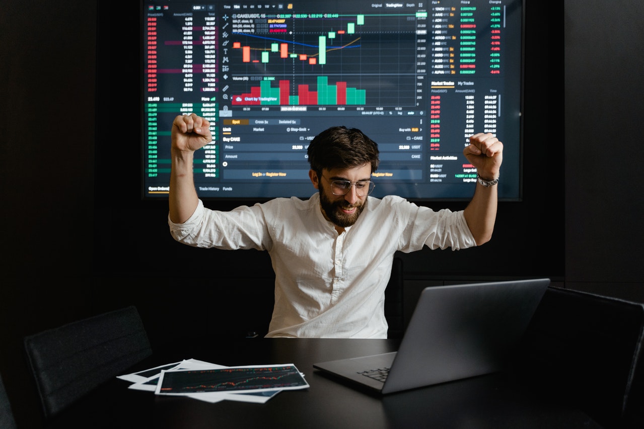 businessman raising his hands for being successful